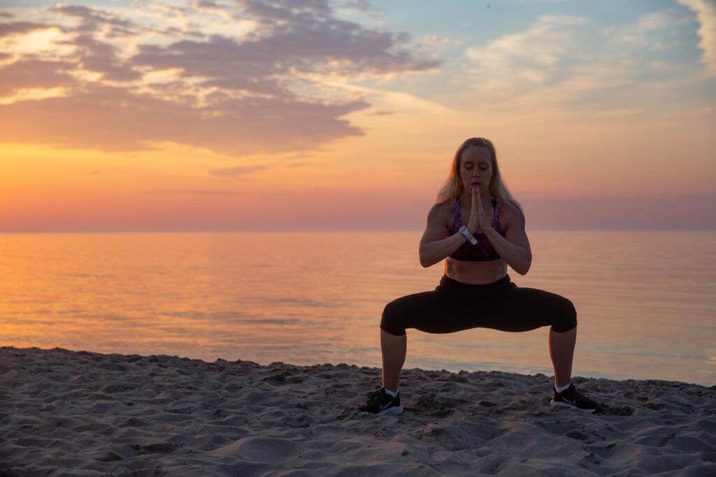 stretching on the beach at sunset